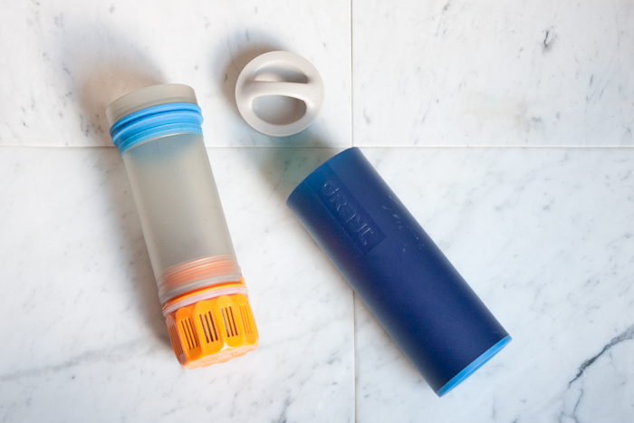 Grayl filter bottle separated on marble tile