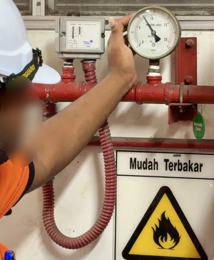 Fire-system pressure gauge reviewed before an underground fire-main investigation at an industrial site in Penang.