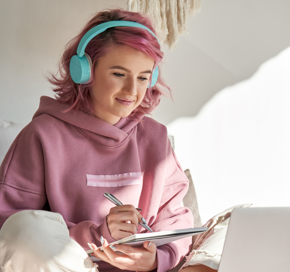 Girl listening to audiobooks and doing homework