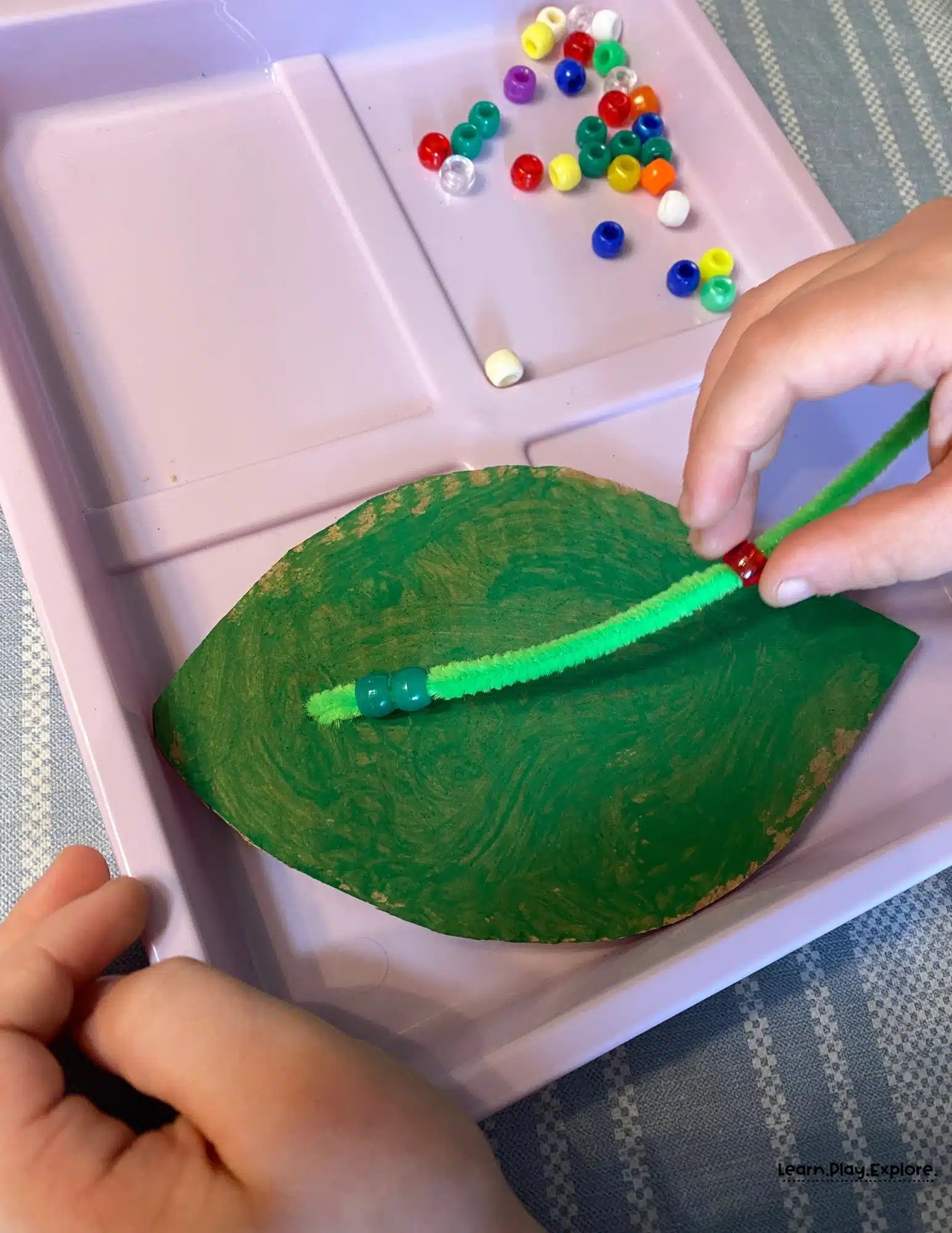stringing beads on a pipecleaner
