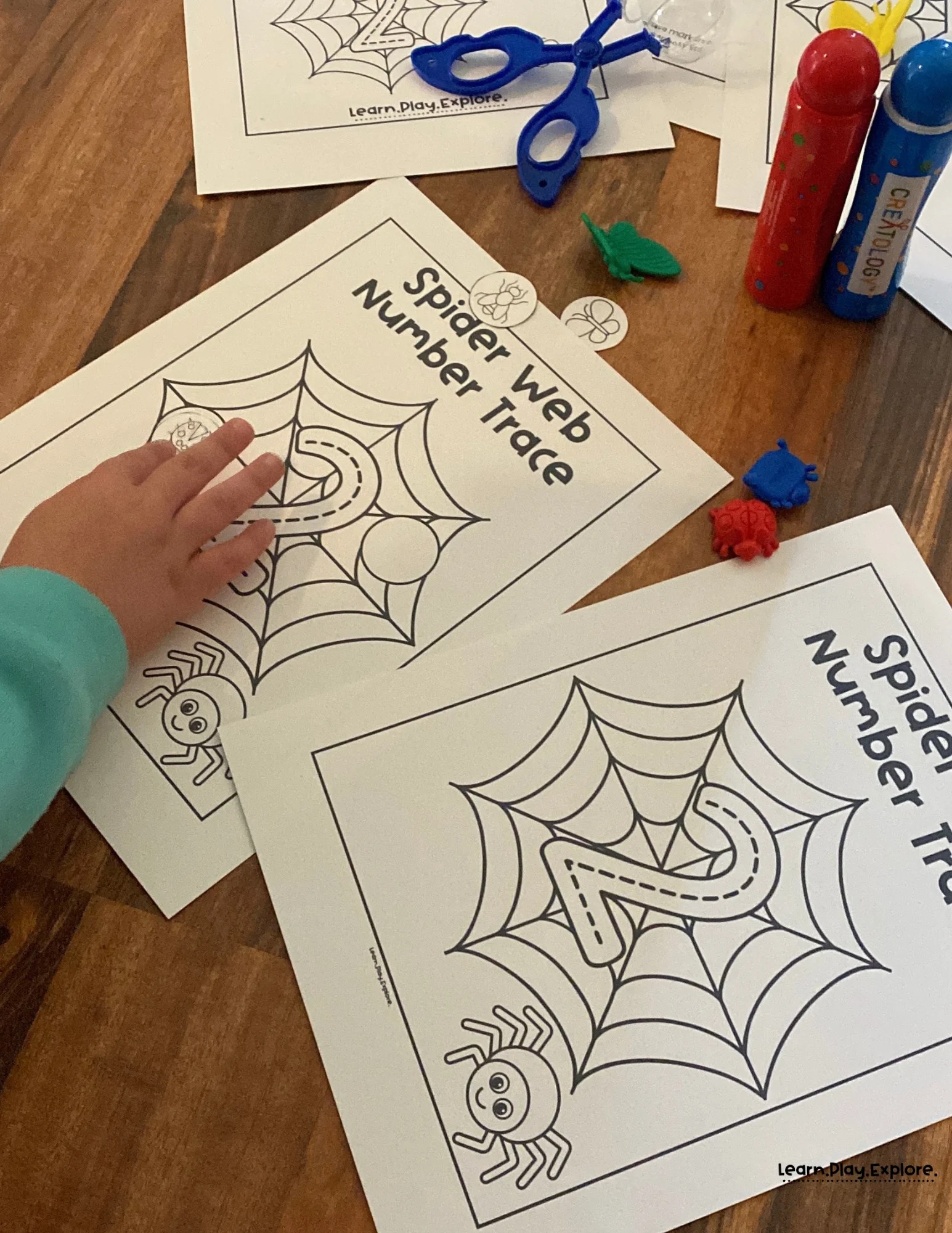 preschooler putting bug on a spiderweb printable