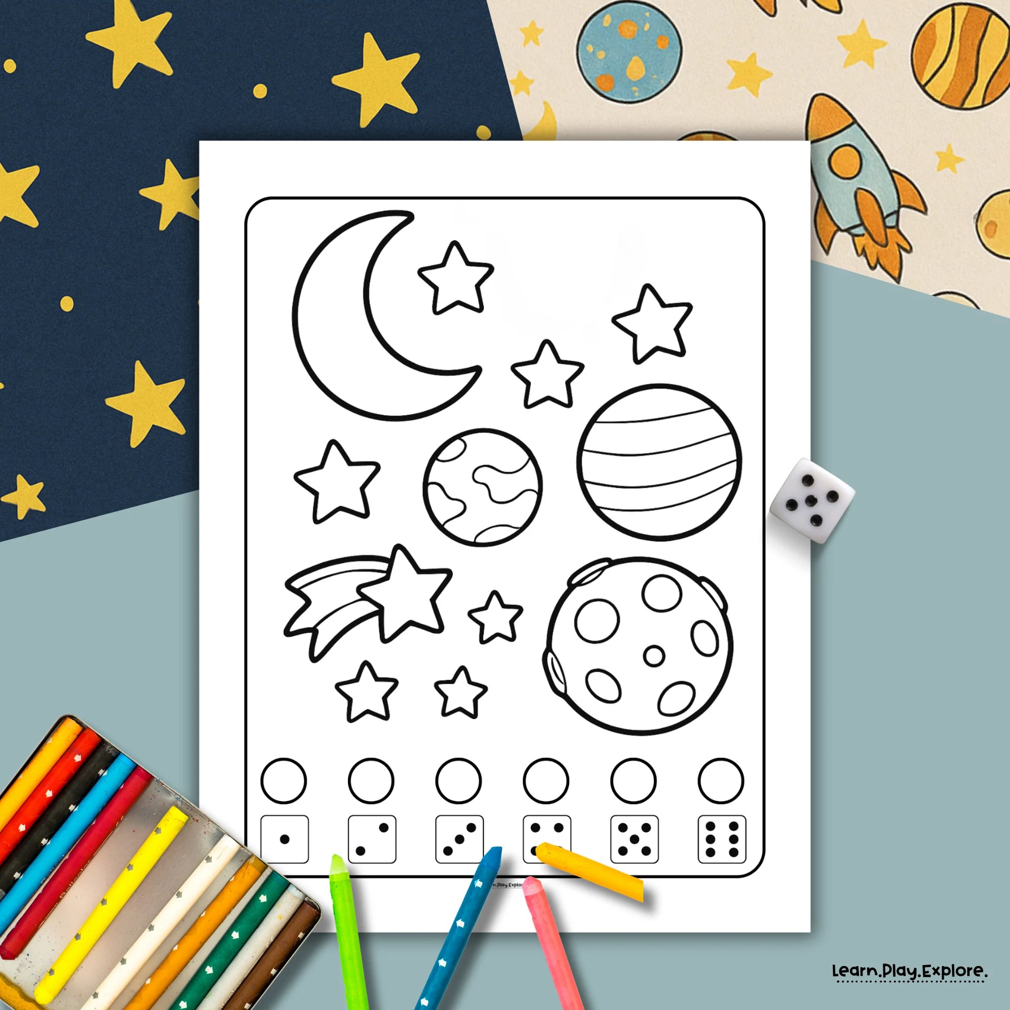 printable space theme for toddlers and preschoolers  activity. This is a roll and color activity. the page features planets and stars. there are color crayons ready to use and a dice next to the page. the printable is sitting on space themed colored paper
