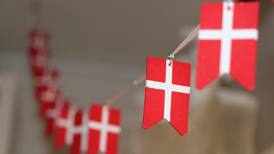 Small Danish flag decorations hanging on a string.