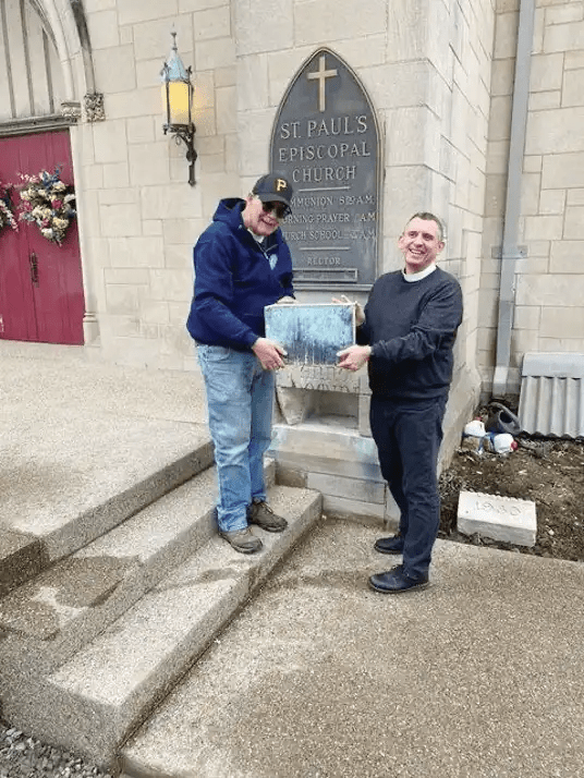 Geoff Hurd (left) and Reverend Noah Evans (right) removed the time capsule from the cornerstone prior to summer renovations. (Photo provided)