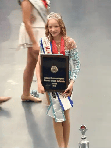 Elizabeth Baldridge poses with her sash, trophy and plaque after winning a national title at the National Baton Twirling Association Championships at Notre Dame in July. Photo provided)
