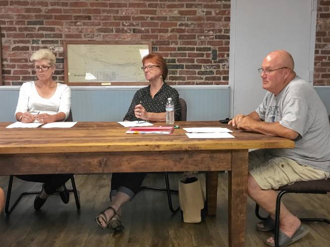 Select Board members Carla Mary, Maggie Bickford and Doug Reardon speak with Fire Chief Charles Buttrick about increasing access to the communications tower on Barrett Hill Road during its meeting Wednesday.