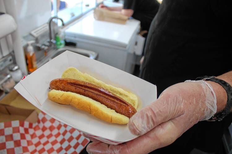 Jerry Willis, owner of the Fryer Truck in Bennington, serves up fresh fries and a fish taco to a customer.