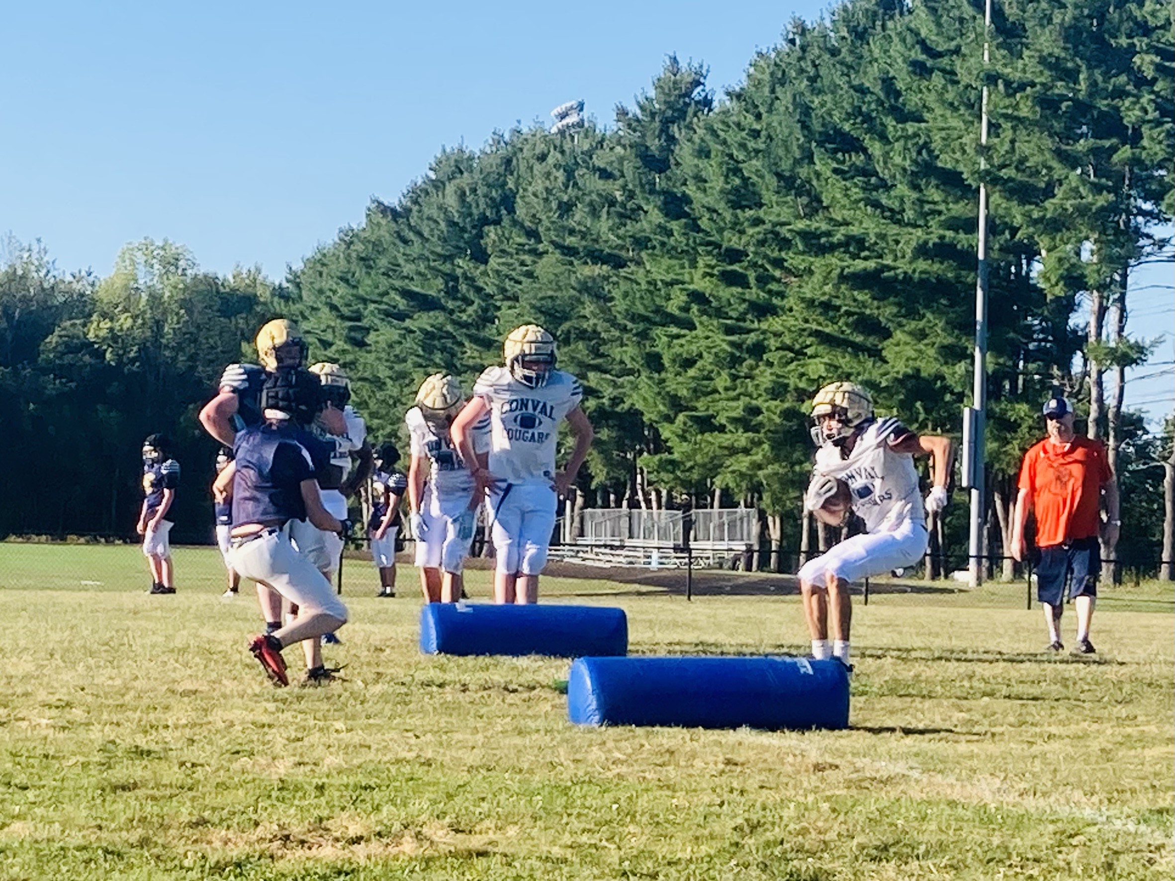ConVal football teams runs drills in preseason practice.