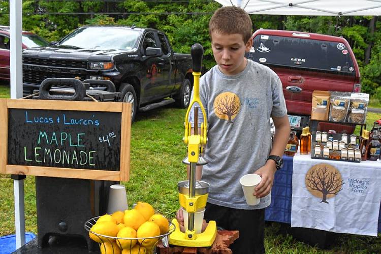 Lucas Collins of Midnight Maples makes a hand-pressed maple lemonade during last year's Lyndeborough Community Day.