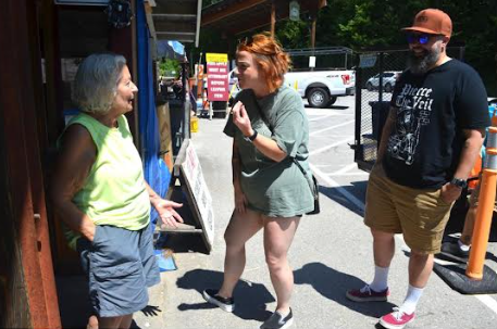 Carol Burgess chats with Kelly Paine and Bryan Corderio of Greenville.