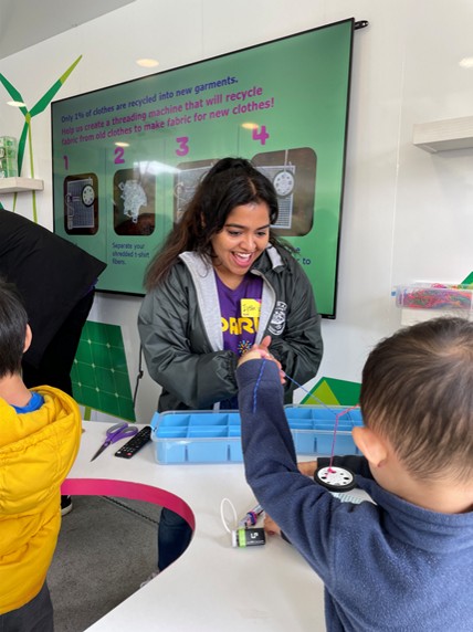 Millipore Sigma employees teach hands-on STEM lessons inside the Curiosity Cube mobile science lab.