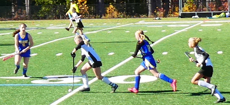 Boynton eight grader Reese Alix dribbles the ball, while South Meadow's Olivia Swinyer races to defend. Boynton's Havana Cormier follows the play.