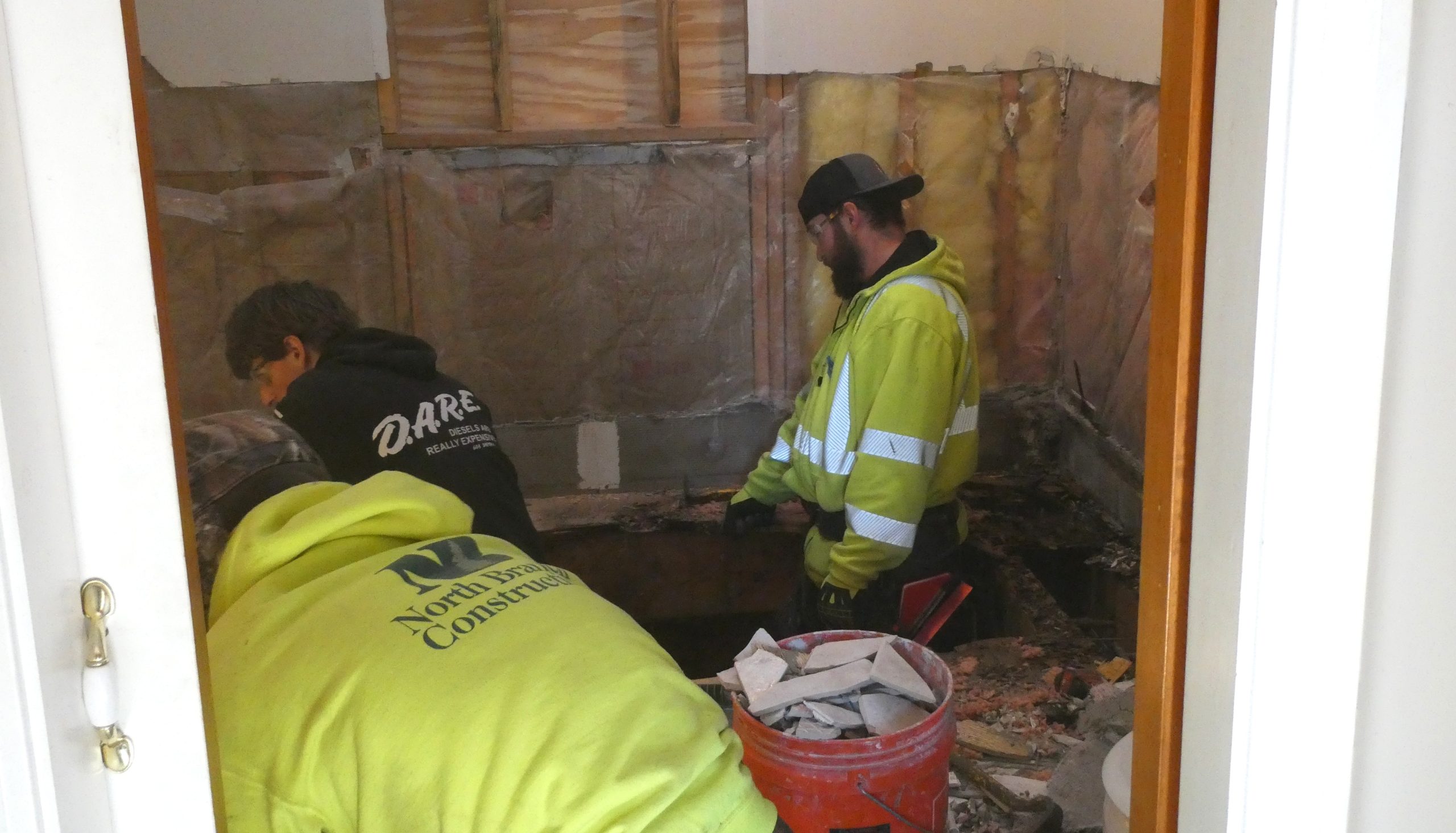 Drew DeStefano (right), a carpentry apprentice at NHTI, works on a bathroom remodel in Loudon as part of a volunteer project with Habitat for Humanity.
