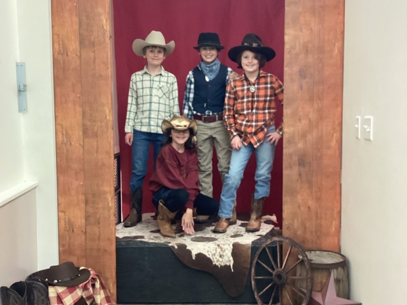 Fourth graders Quenton Proctor, Sonny Landry, Jack Spear, and Annie Bukosfer don cowboy hats for the Boots and Suits dance. COURTESY / Ledger-Transcript