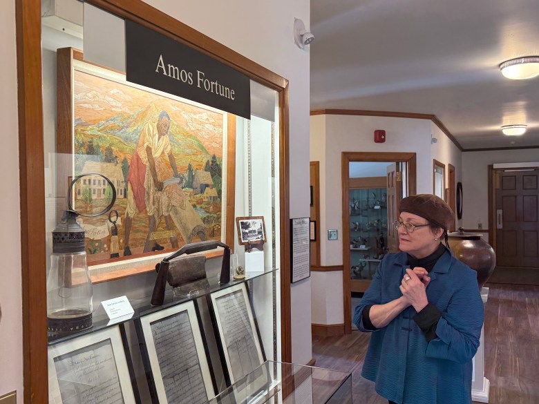 Historical Society volunteer and exhibit curator Jeanne Duval explores the finished exhibits. ASHLEY SAARI / Ledger-Transcript