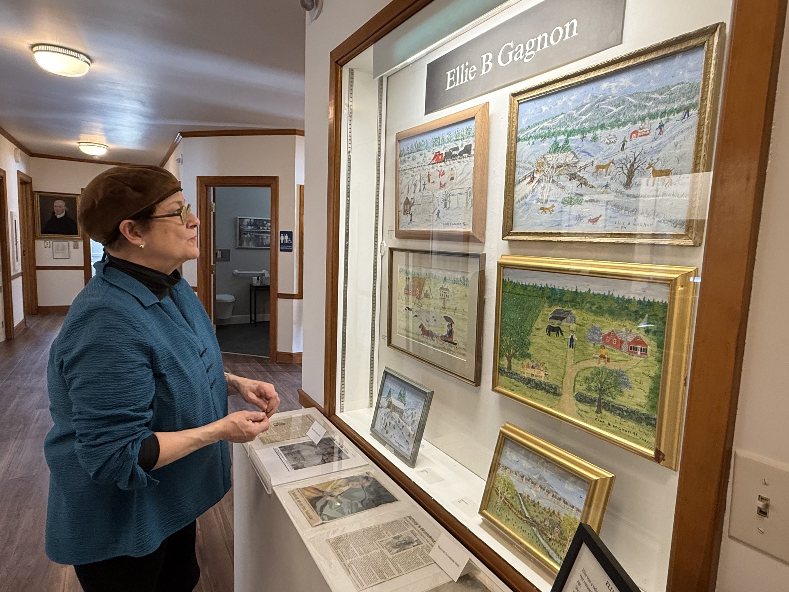 Historical Society volunteer and exhibit curator Jeanne Duval explores the finished exhibits. ASHLEY SAARI / Ledger-Transcript