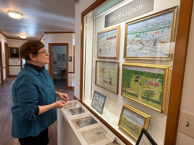 Historical Society volunteer and exhibit curator Jeanne Duval explores the finished exhibits. ASHLEY SAARI / Ledger-Transcript