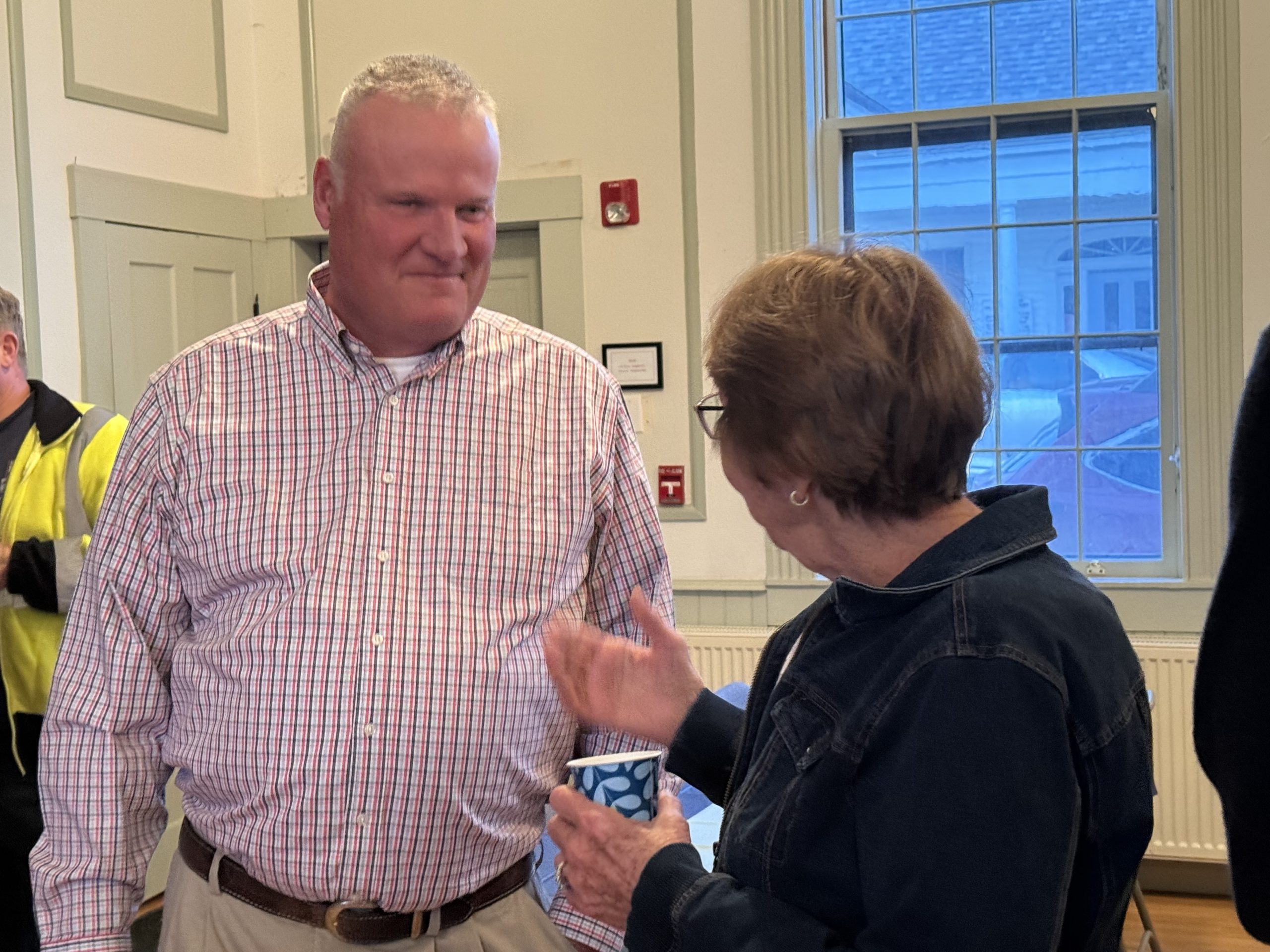 Jim McTague speaks with residents at his retirement party on Friday.