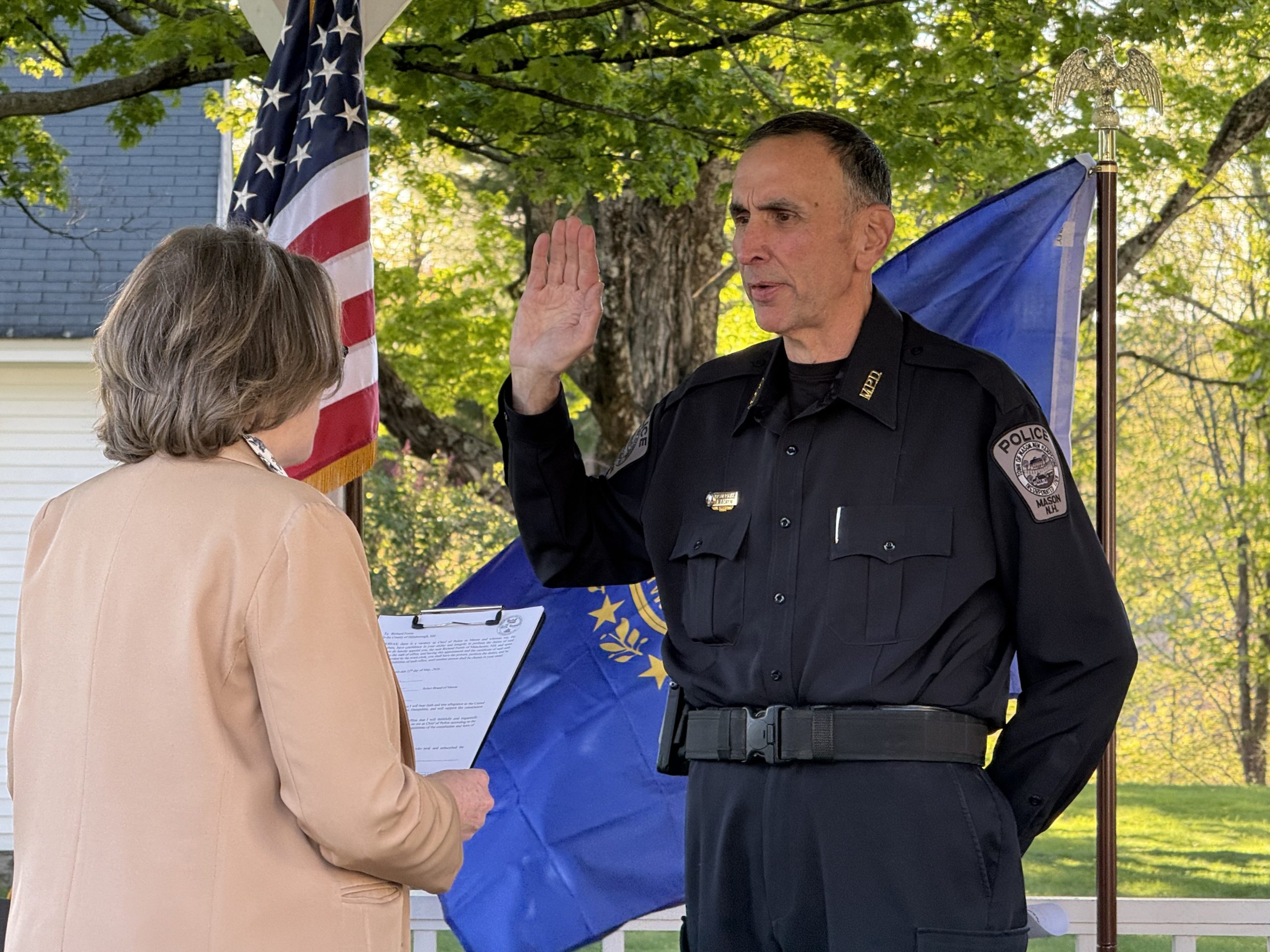 Mason Select Board Chair Kate Batcheller swears in Richard Fortin as police chief.