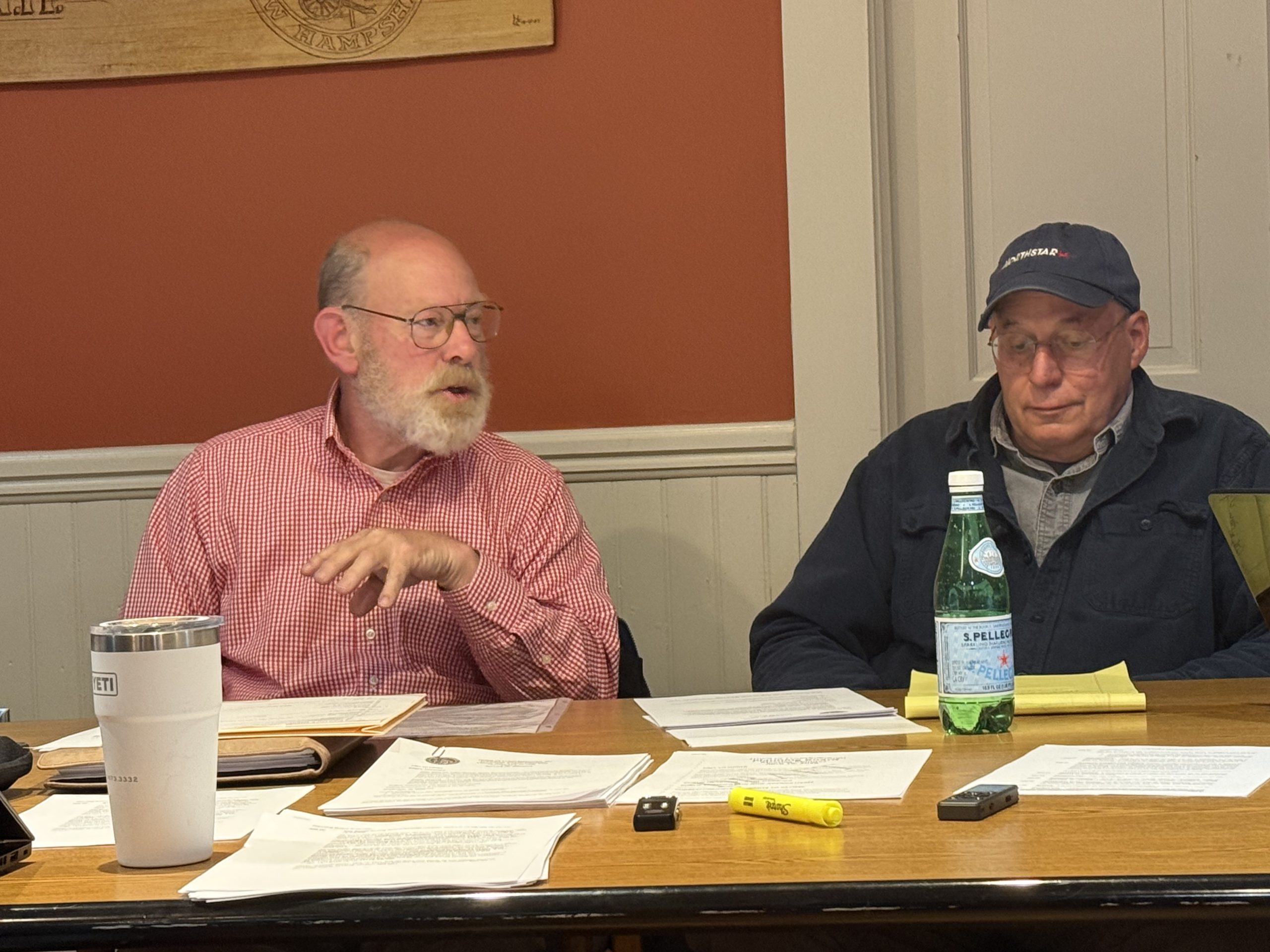 Planning Board Chair Bob Rogers and member Lou Rota discuss final wording on a proposed zoning amendment.