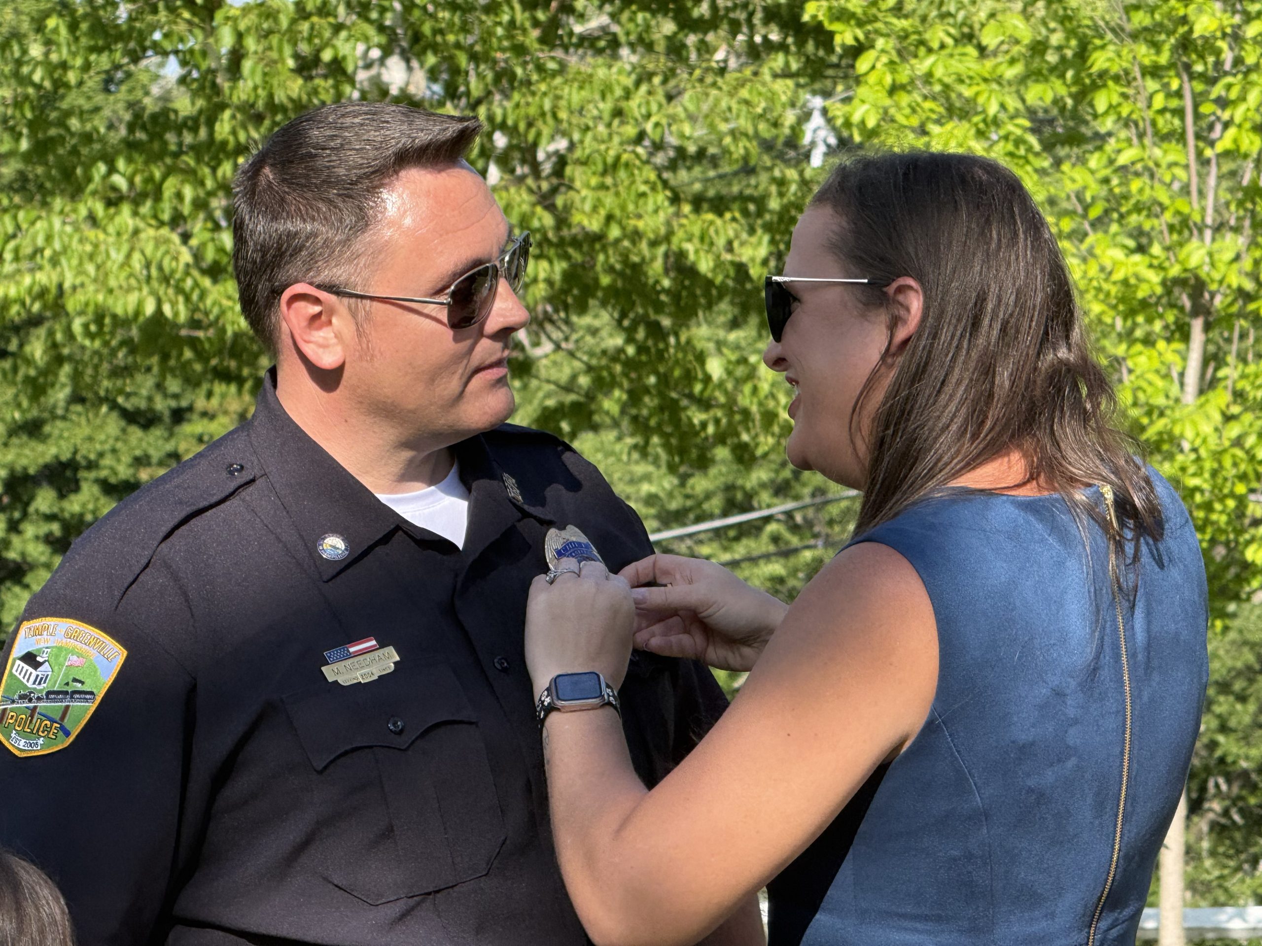 Michael Needham is pinned with his chief's badge by his wife, Leanne Needham.