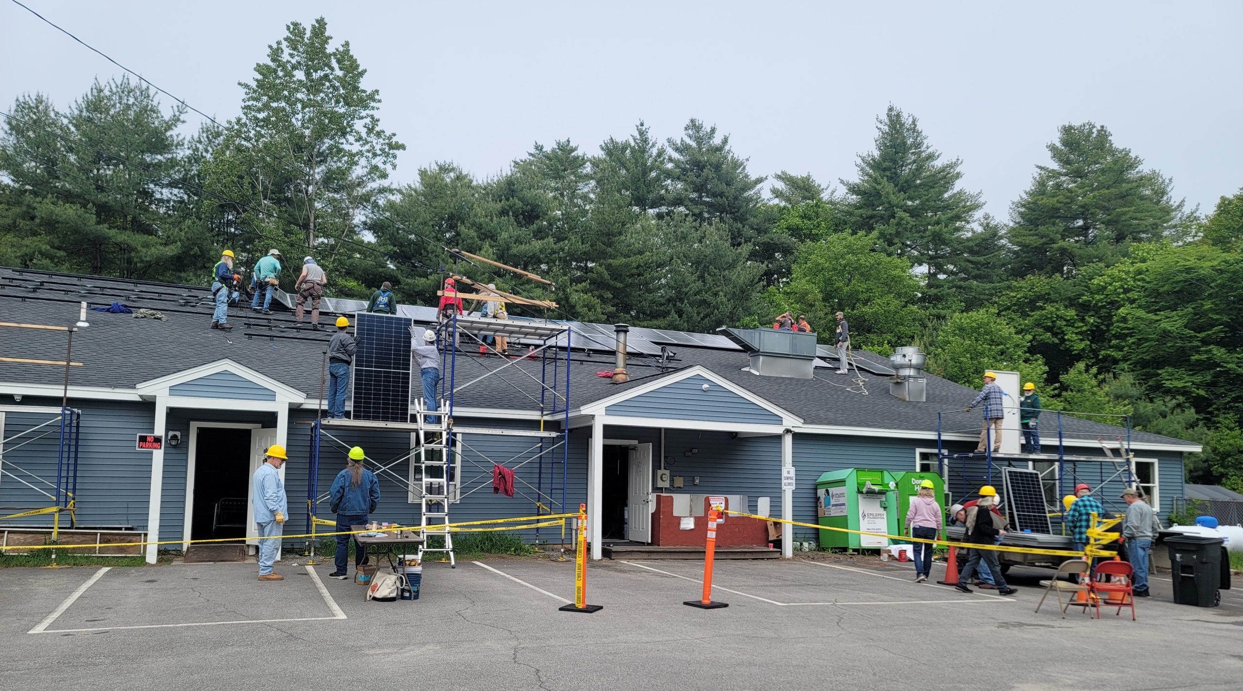HAREI volunteers installing solar panels on the Friends of Forgotten Children food pantry in Concord, Sunday, May 31, 2006