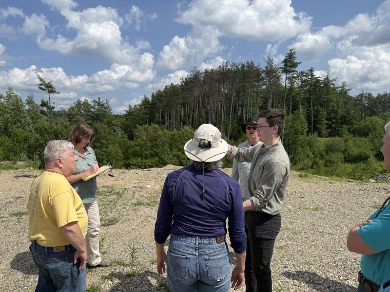 Chuck Ritchie of Fieldstone Land Consultants shows markers on a site plan to the ZBA during a site walk Wednesday.
