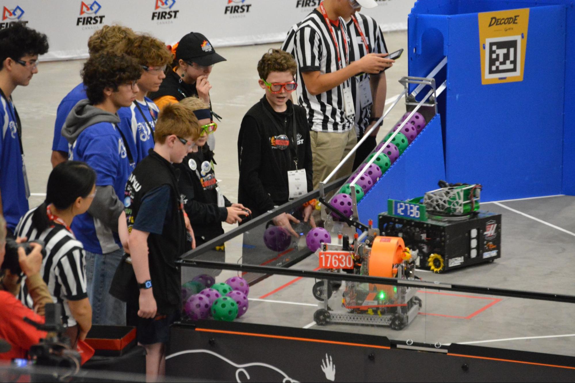 Hot Wings robot, Trilobyte, navigates towards Adian Maher to receive artifacts while Autumn Stone thinks about their next move. In black, left to right: Adian Maher, Kreade Stenersen, Autumn Stone, and Dylan Charles.