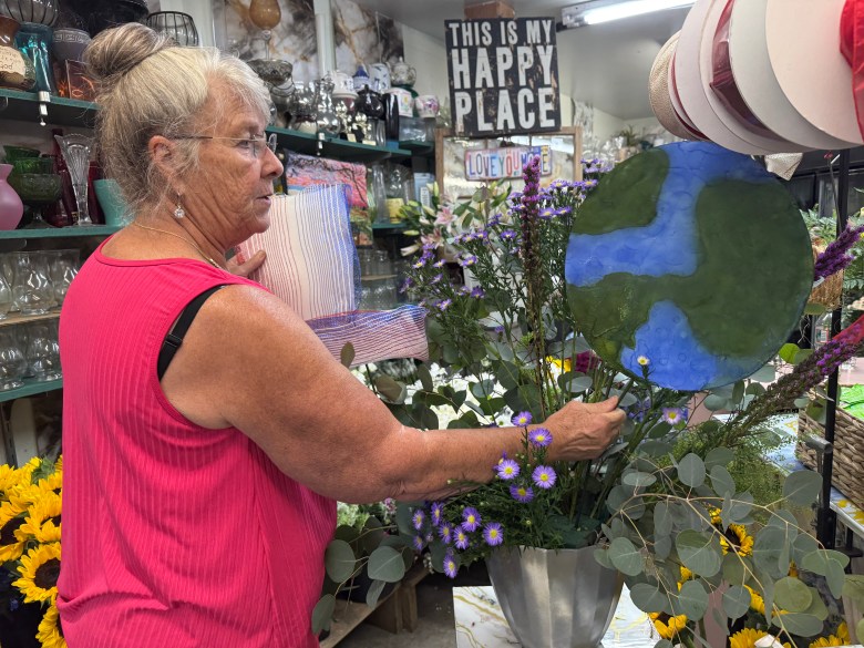 Bonnie Coll Cutter creates a floral arrangement for the Amos Fortune Forum.
