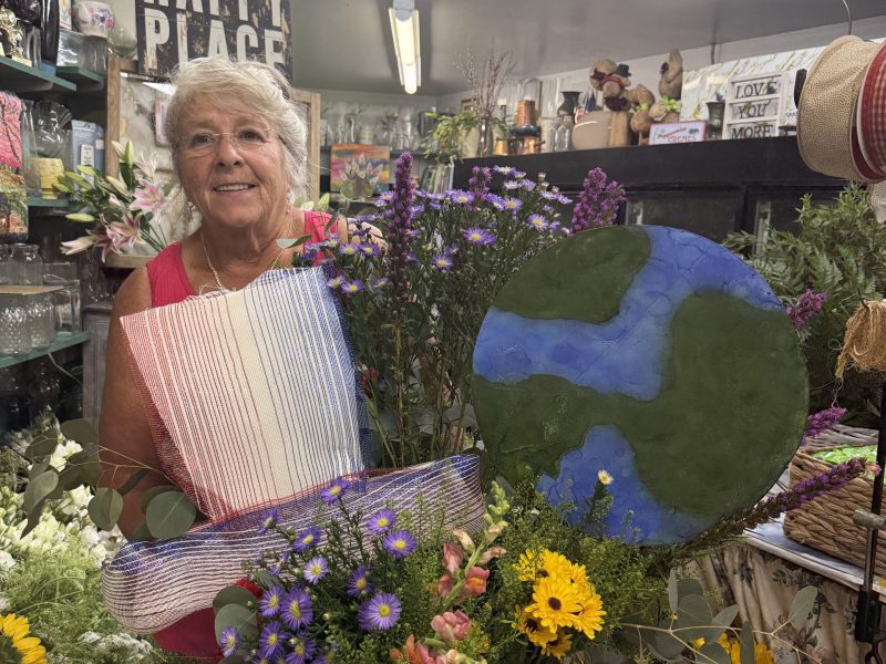 Bonnie Coll Cutter creates a floral arrangement for the Amos Fortune Forum.