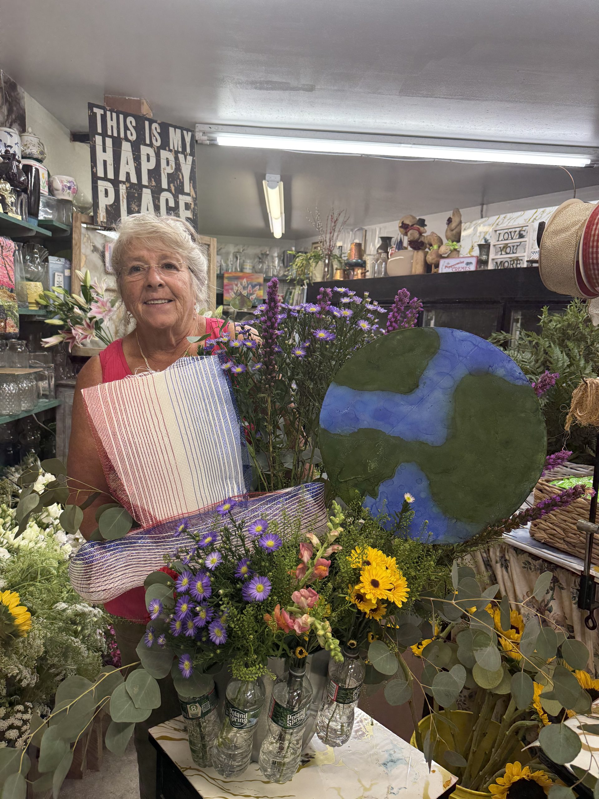 Bonnie Coll Cutter creates a floral arrangement for the Amos Fortune Forum.