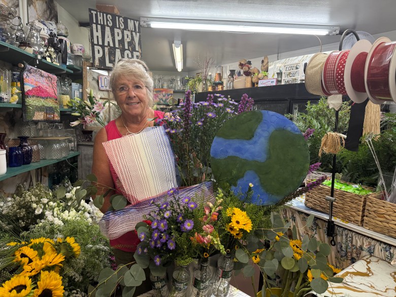 Bonnie Coll Cutter creates a floral arrangement for the Amos Fortune Forum.