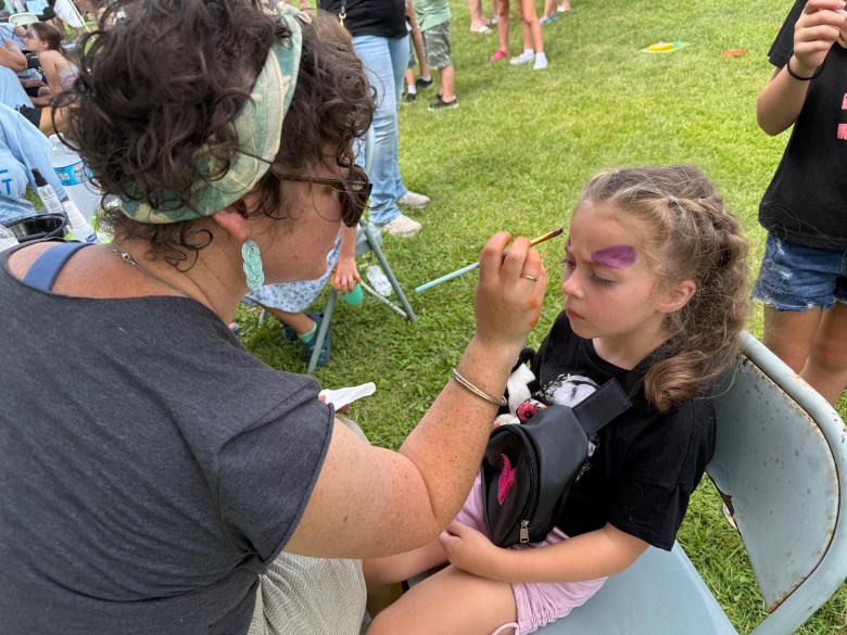 Eryka Kuusisto paints a butterfly on Natalya Coyle of Jaffrey at Jaffjam.