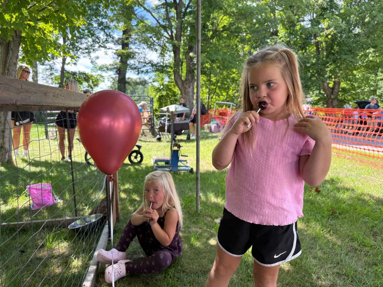Valley Salo of Rindge and Halle Cutter of New Ipswich enjoy lollipops and visiting the petting zoo.