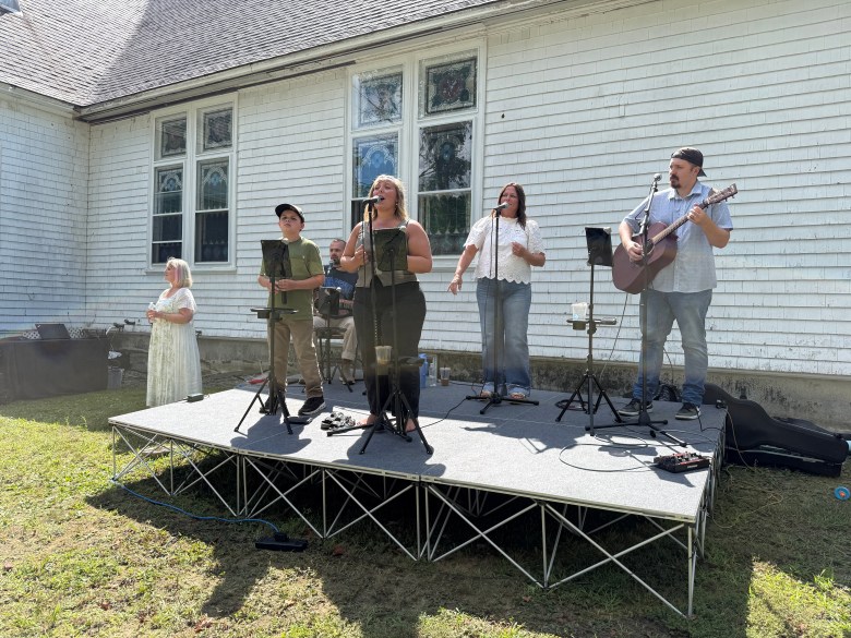 The Christian Outreach band provides live music.