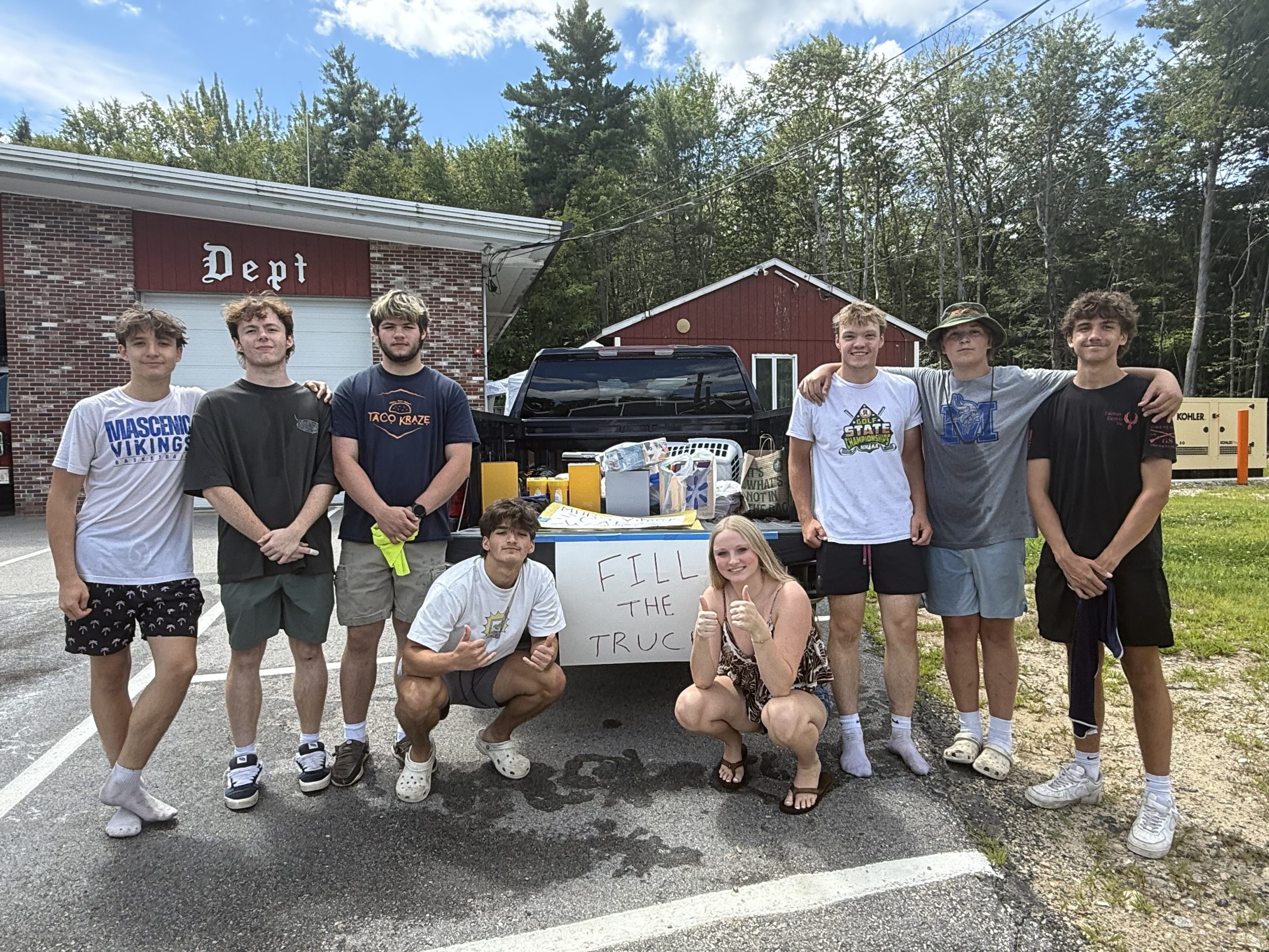 Vikings Basketball players with donations from the community that will be given to teachers at the start of the school years. Left to right: Austin Martin, Killian Duthie, Zachary Alix, Cayden Emerson, Molly Lyons, Colin Koukkari, Reed Carignan and Eli Mack.