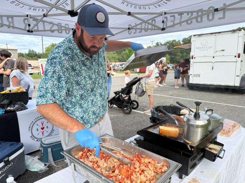 John Jackson serves up lobster rolls at the  Lobster Lovers Food Company tent. 