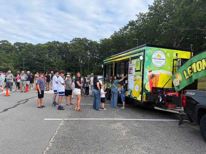 Residents line up during a Food Truck Night fundraiser at Mascenic Regional High School on Friday night.