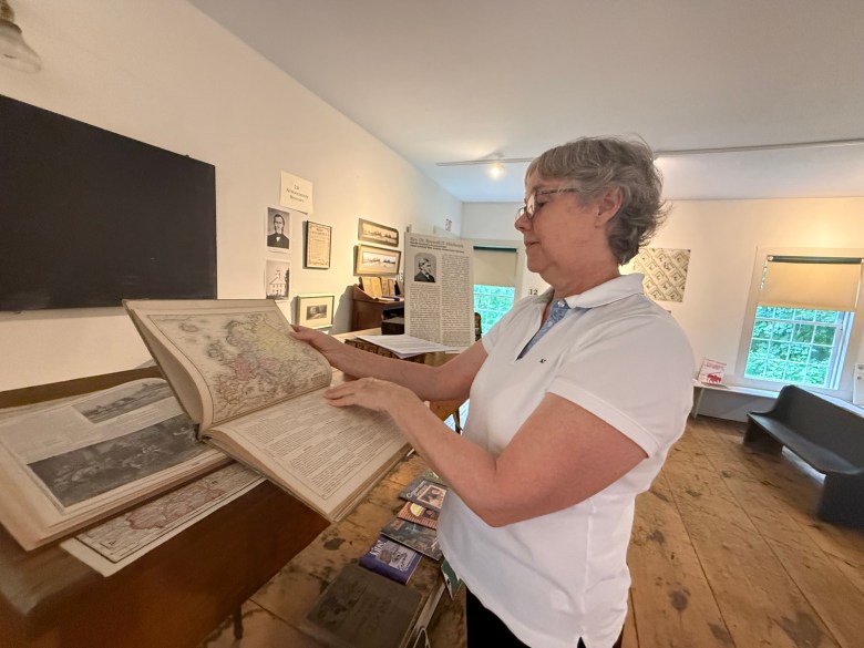 Sara Hamlen examines an old atlas.