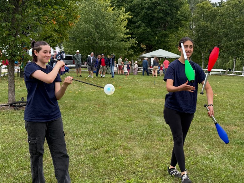 Nora Glass and Ella Glass of Brookline and Flying Gravity Circus provide juggling entertainment.