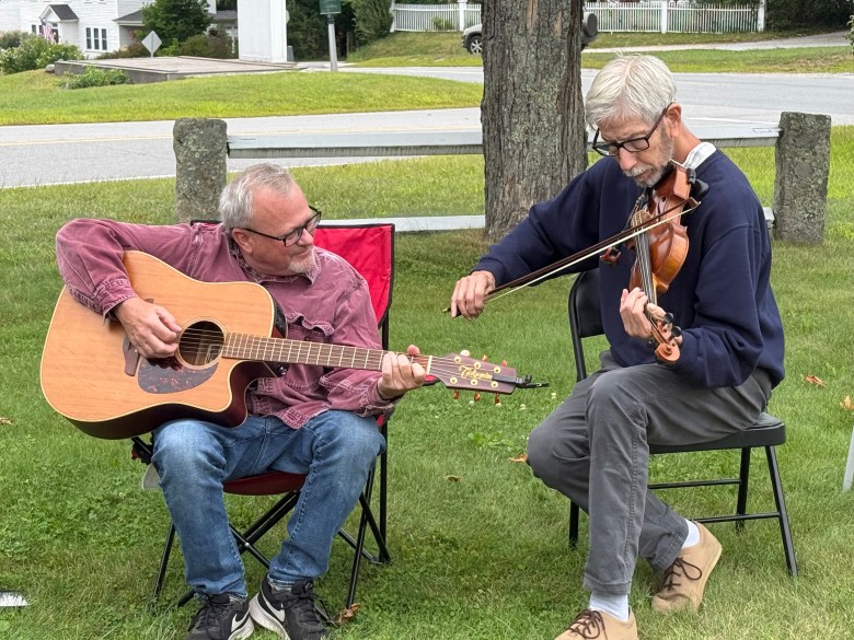 Tom Rousseau, left, and Dan McShane provide guitar and fiddle music.