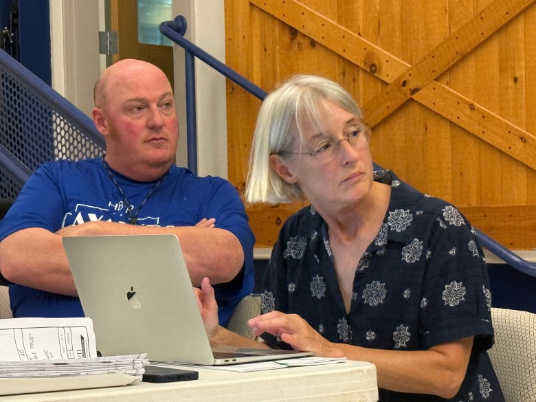 Planning Board members Chris Jones and Jenny Scholl listen to testimony.