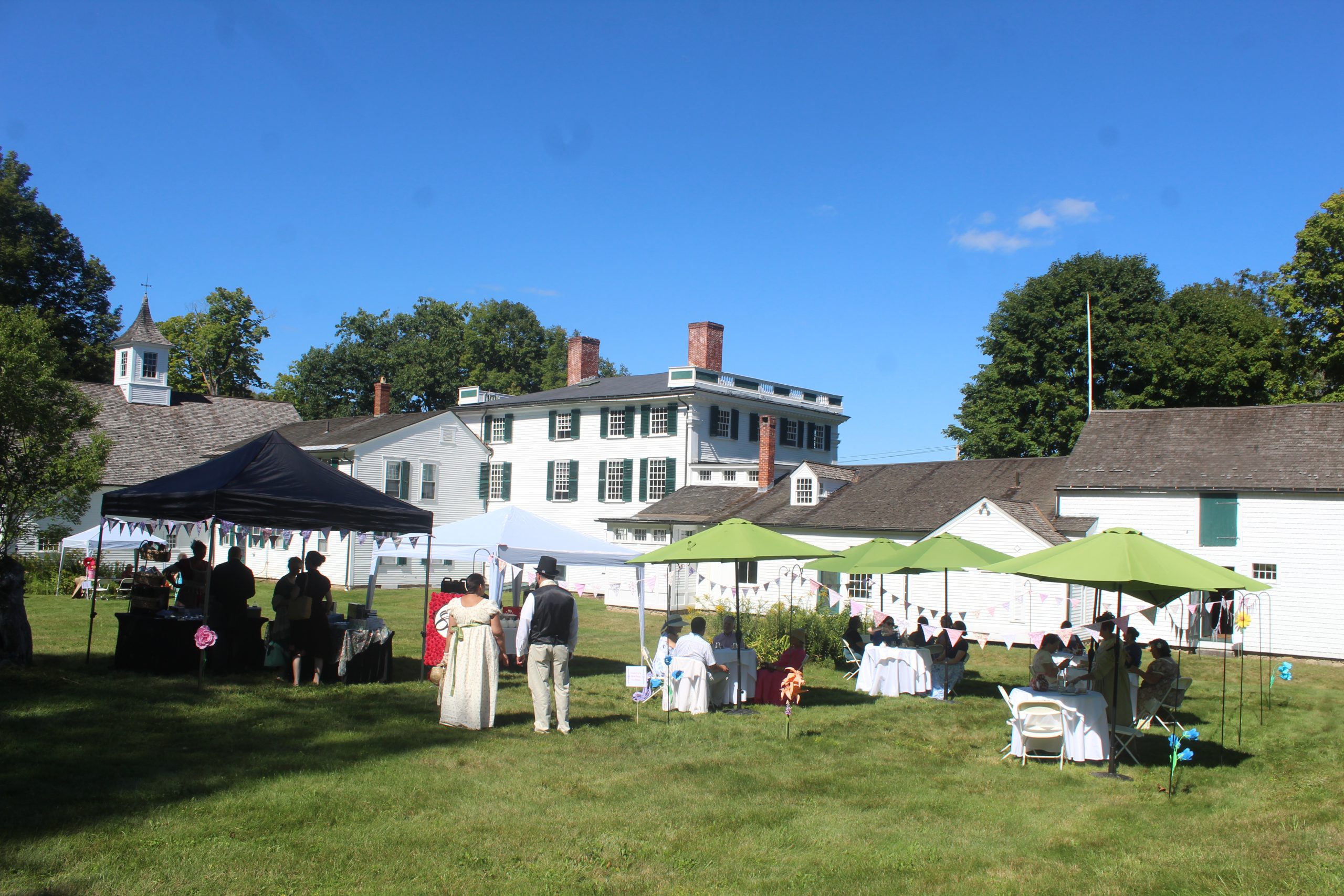 Visitors have a tea party on the lawn of the Barrett mansion, also known as Forrest Hall, in New Ipswich on Saturday.