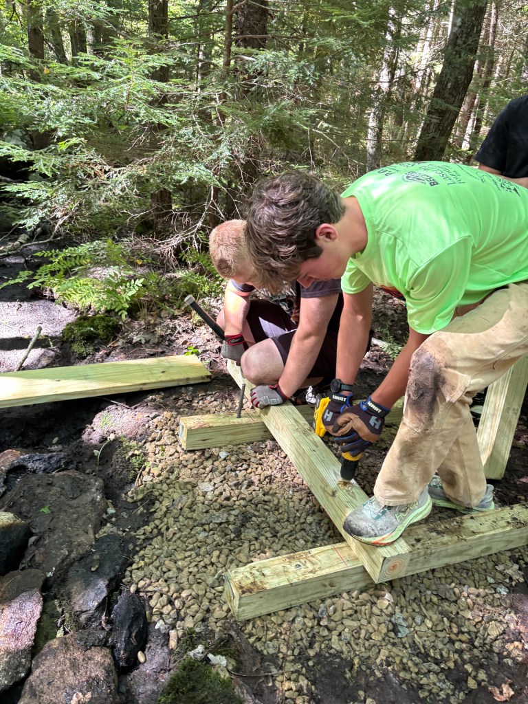 David Levesque and Aaron Graham drilling in the abutment into the ground.
