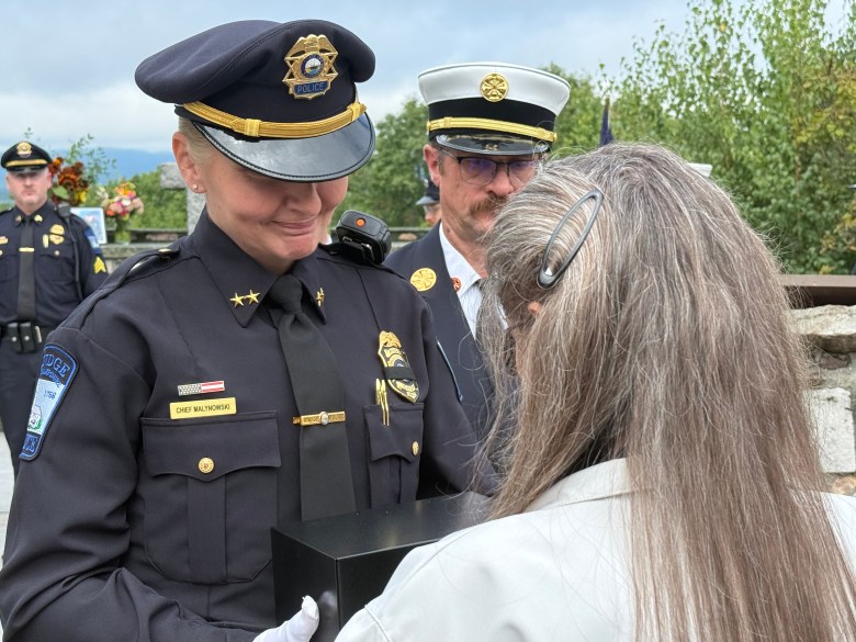 Police Chief Rachel Malynowski presents Harris' ashes to his wife, Judy Harris.