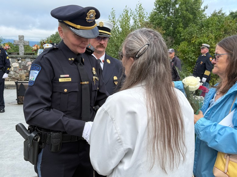 Police Chief Rachel Malynowski presents Harris' ashes to his wife, Judy Harris.