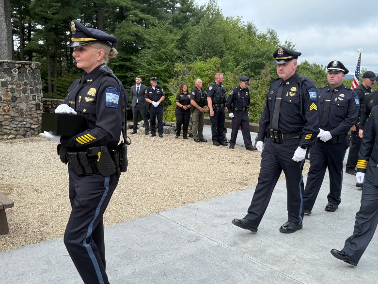 A contingent of police and fire personnel escort Harris' ashes.