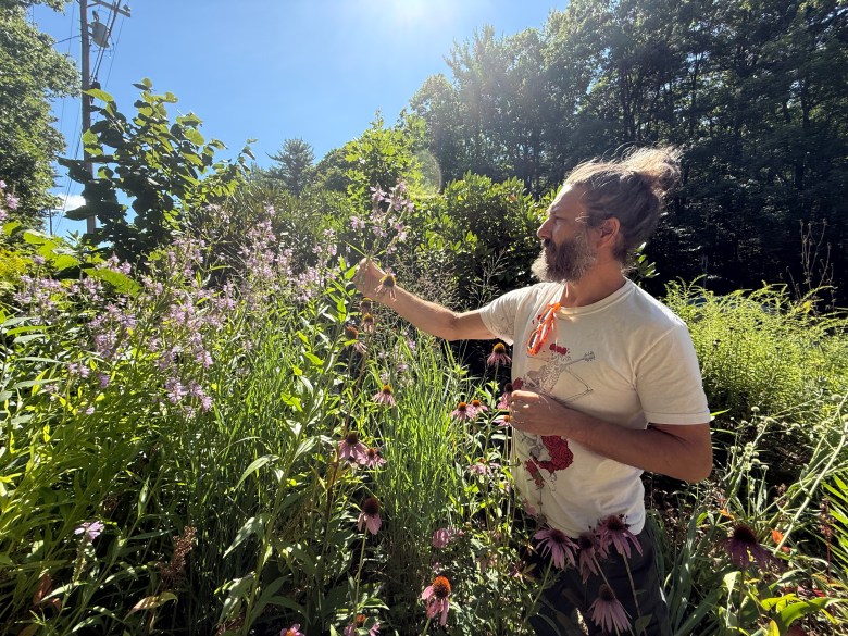 Aaron Abitz of Fassett Farm walks through demonstration gardens of native plants.