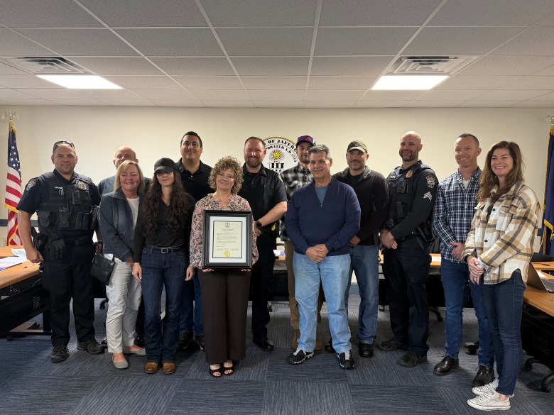 Police administrator Denise Chatel with members of the police department, Select Board, and loved ones celebrating her 25-year anniversary working for the police department.
