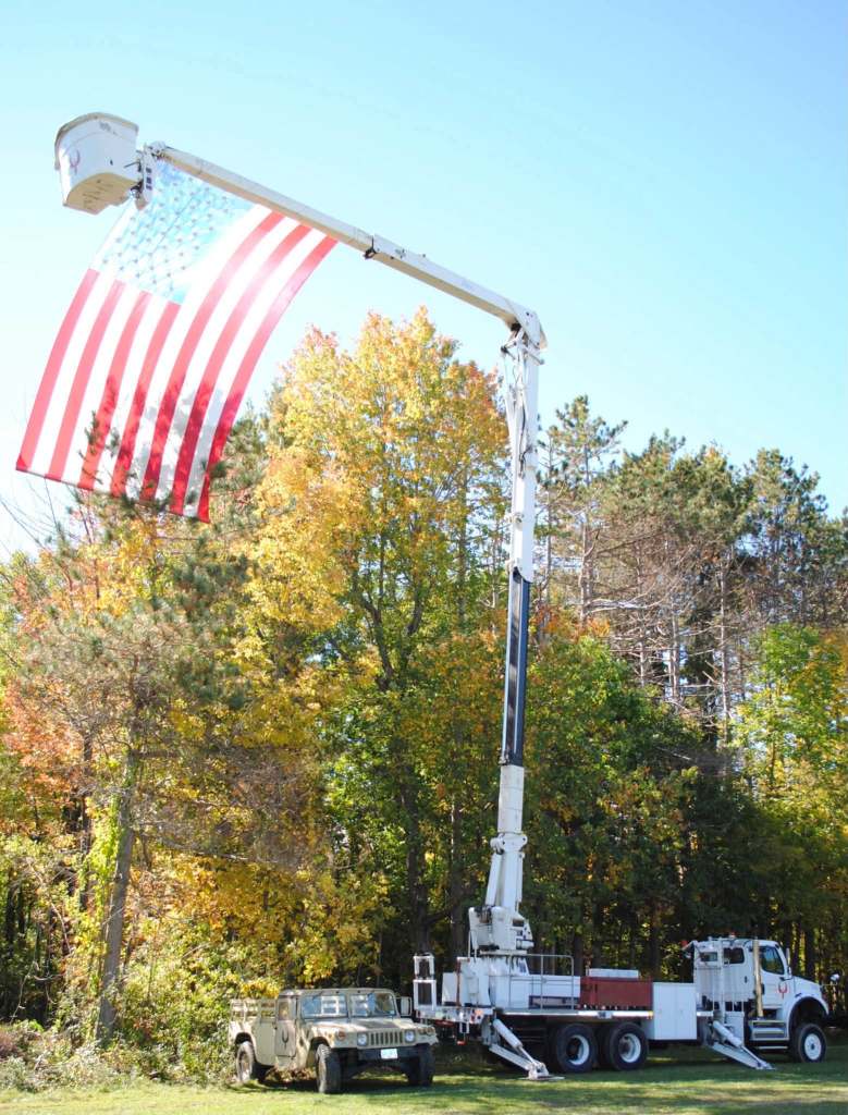 An American flag hangs over the Touch a Truck area.